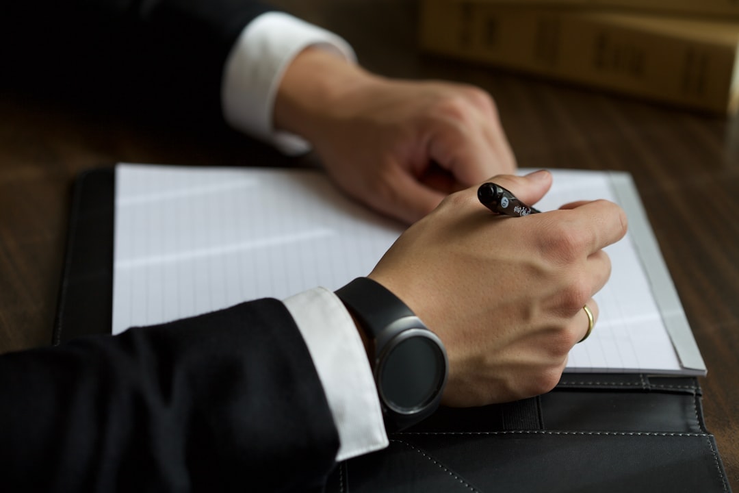 a-person-in-a-suit-writing-on-a-document-bofrosjzrns